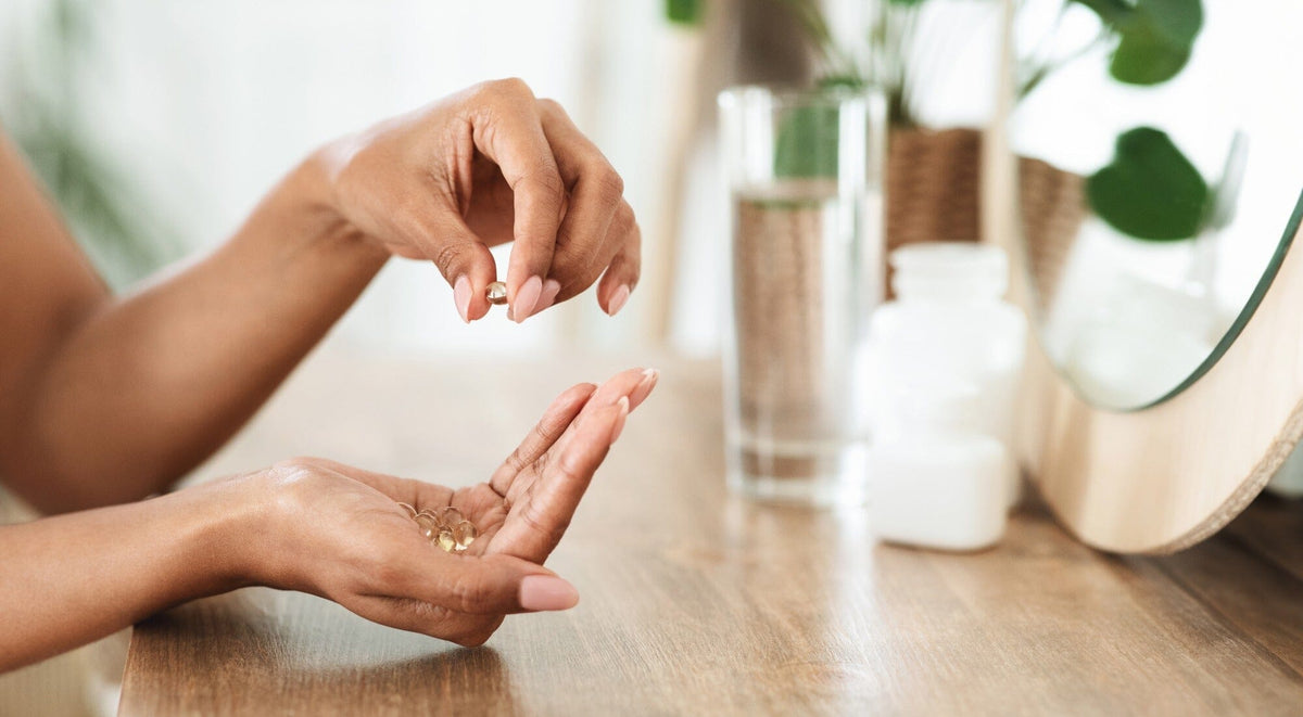 Woman holding supplements in her hand