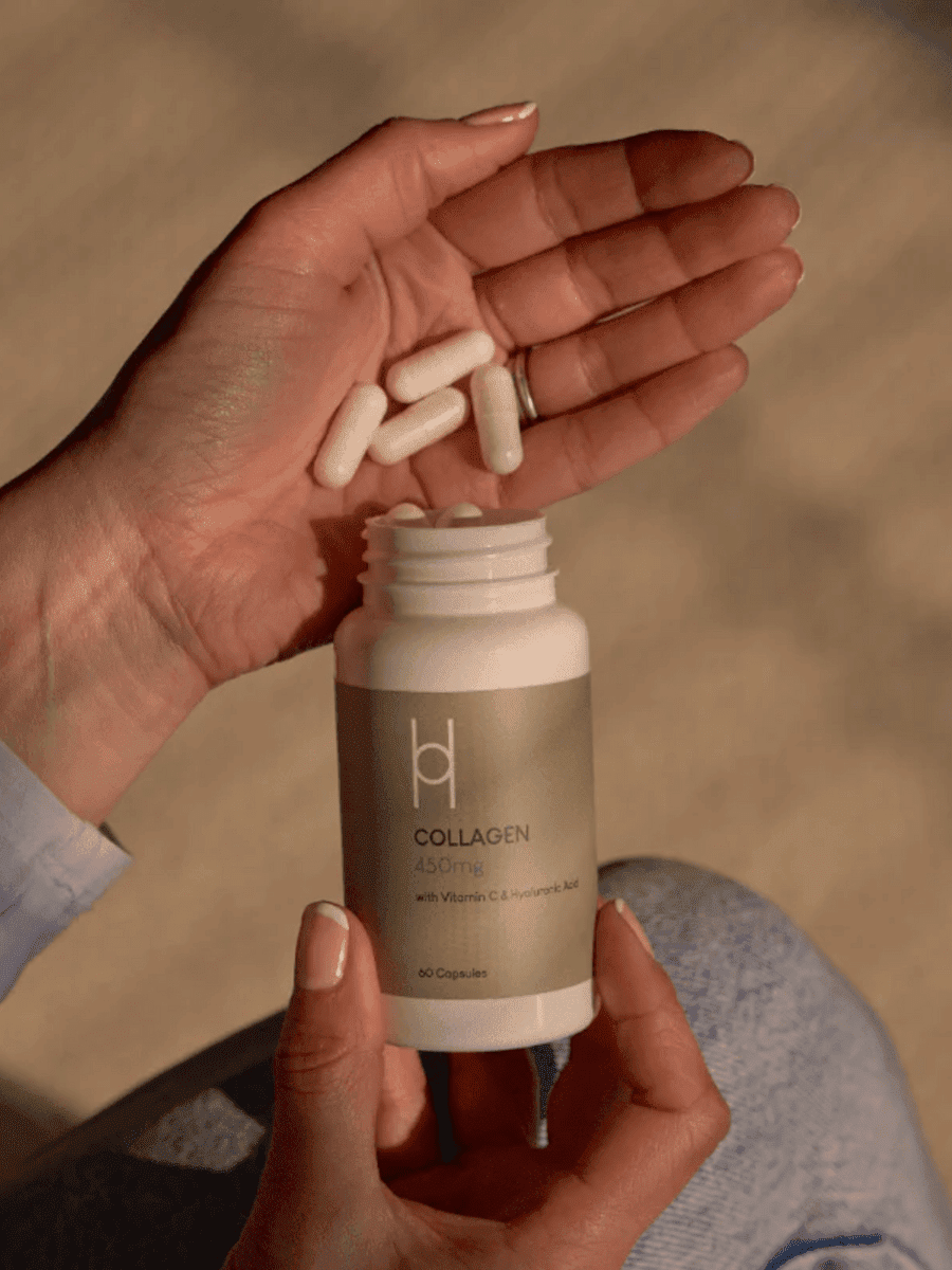 Harrogate Organics Marine Collagen with Hyaluronic Acid and Vitamin C supplement held in a woman's hand.