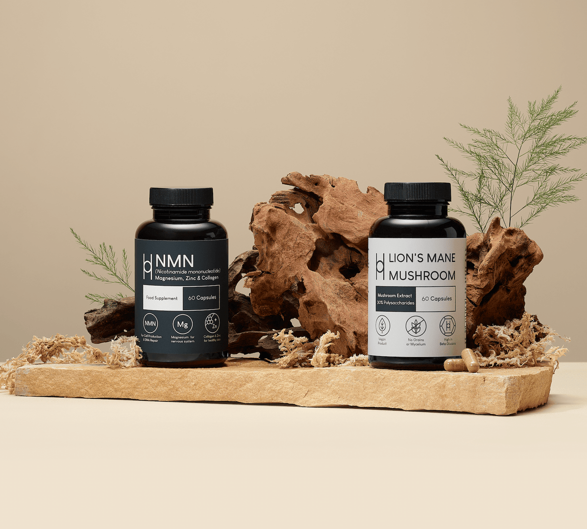 Two supplement bottles labeled “NMN” and “Lion’s Mane Mushroom” are displayed on a wooden tray with natural moss, wood, and fern leaves against a beige background.
