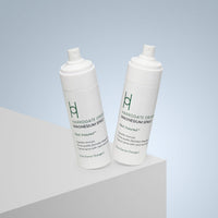 Two bottles of Harrogate Organics Magnesium Spray Duo Bundle (2 x 150ml) with white spray tops sit on a white surface against a light blue background. The minimalist labels feature green text, showcasing this calming sleep aid.