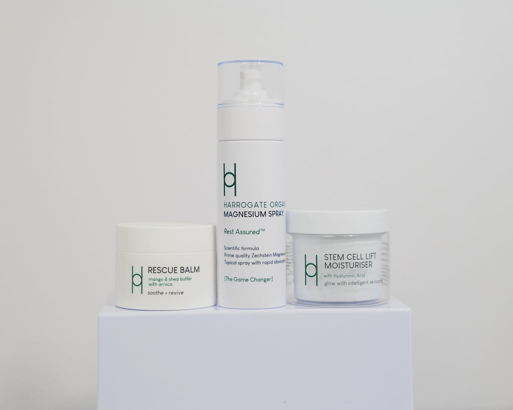 The Best Sellers Trio rests on a white platform, each item displayed in sleek, minimalist white packaging that adds a modern touch.