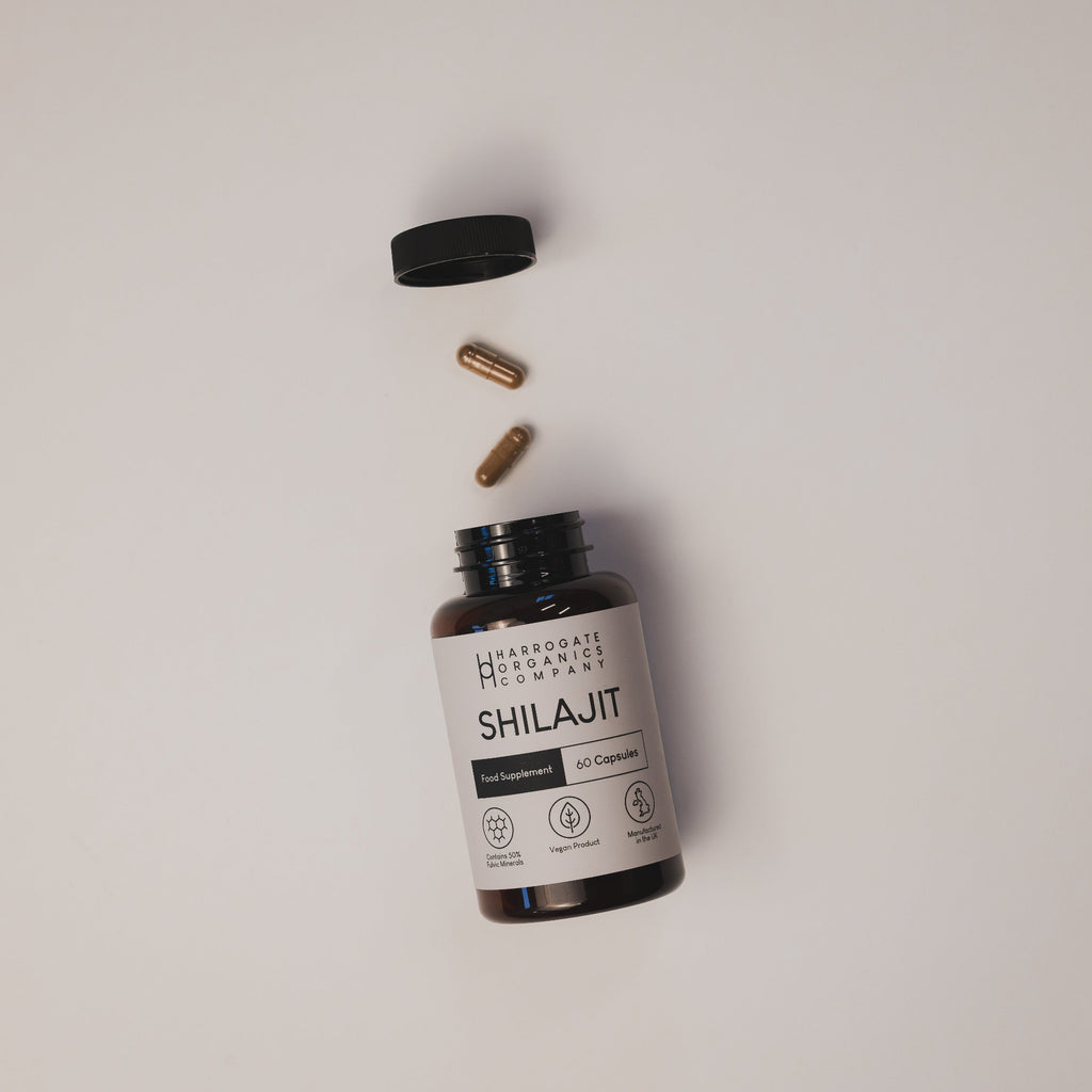 Supplement bottle labeled 'Shilajit' with capsules on a light gray background