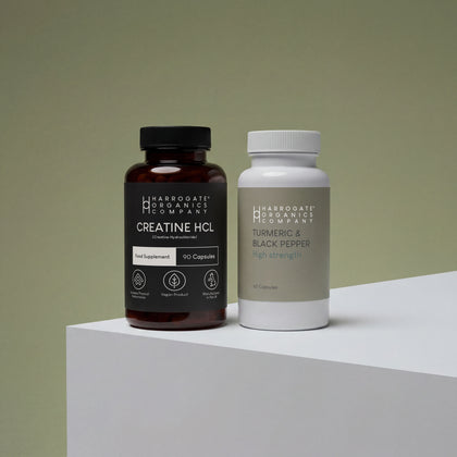 The Creatine HCL & Turmeric & Black Pepper Supplement Bundle from Harrogate Organics Company is displayed side by side on a white surface with a muted green background.
