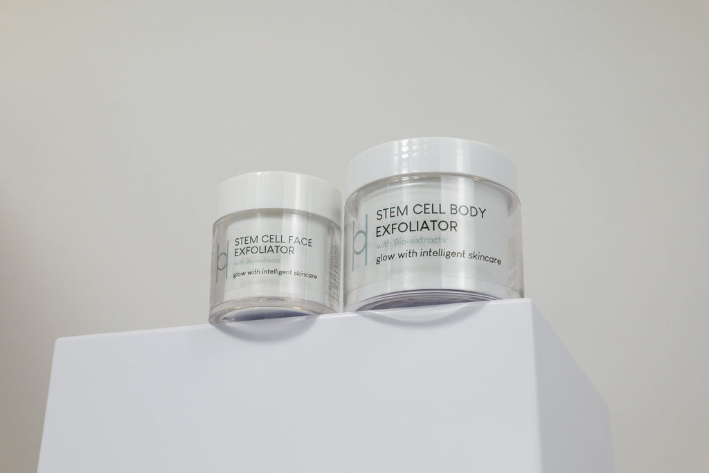 The Exfoliator Duo sits on a white surface against a plain light background, showcasing glow with intelligent skincare’s essentials for achieving radiant skin.