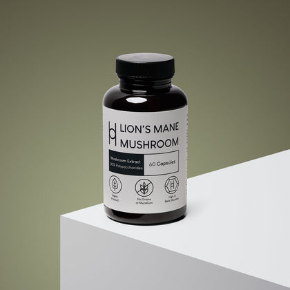 A dark brown bottle labeled "Lion's Mane Mushroom Supplement 800mg Per Serving – 30 Day Supply – 60 Capsules" sits on a white surface. The label notes vegan, no grains or mycelium, beta-glucans, and cognitive health support.