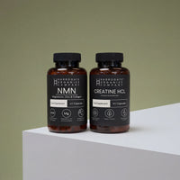 The NMN & Creatine HCL Supplement Bundle from Harrogate Organics is displayed on a white surface against a green background—ideal for supporting your daily routine and wellness foundation.