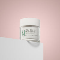 A white jar labeled Day & Night Skin Repair Bundle with hyaluronic acid and collagen nutrition sits on a white surface against a soft pink background.